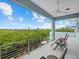 Relaxing balcony overlooking a lush waterfront landscape at 705 Jungle Queen Way, Longboat Key, FL 34228