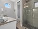 Contemporary bathroom with a walk-in shower and gray tile at 705 Jungle Queen Way, Longboat Key, FL 34228