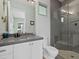 Modern bathroom with gray tile, floating vanity, and walk-in shower at 705 Jungle Queen Way, Longboat Key, FL 34228