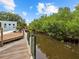 Serene canal view with a wooden dock, perfect for enjoying Florida's natural beauty at 705 Jungle Queen Way, Longboat Key, FL 34228