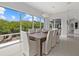 Bright dining room with large windows overlooking a deck and water views at 705 Jungle Queen Way, Longboat Key, FL 34228