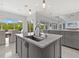 Modern kitchen island with sink and breakfast bar at 705 Jungle Queen Way, Longboat Key, FL 34228