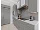 Modern kitchen with gray cabinets and quartz countertops at 705 Jungle Queen Way, Longboat Key, FL 34228