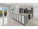 Modern kitchen with gray cabinetry and large island at 705 Jungle Queen Way, Longboat Key, FL 34228