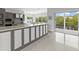 Modern kitchen with gray cabinets, quartz countertops and island at 705 Jungle Queen Way, Longboat Key, FL 34228