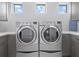 Laundry room with side-by-side washer and dryer at 705 Jungle Queen Way, Longboat Key, FL 34228