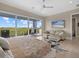 Main bedroom features a king bed, sitting area, and sliding doors to a balcony at 705 Jungle Queen Way, Longboat Key, FL 34228