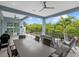 Covered patio features a large dining table with seating at 705 Jungle Queen Way, Longboat Key, FL 34228