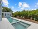 Inviting pool and spa with a large wooden deck and lush landscaping at 705 Jungle Queen Way, Longboat Key, FL 34228