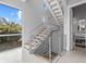 Modern staircase with metal railings and natural light at 705 Jungle Queen Way, Longboat Key, FL 34228