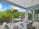 Relaxing waterfront patio with seating area and view of boat at 705 Jungle Queen Way, Longboat Key, FL 34228