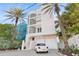 Three-story house with white walls, glass block accents, and a two-car garage at 648 Beach Rd, Sarasota, FL 34242