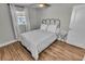 Bedroom with metal bed frame and wood-look flooring at 705 S Lockwood Ridge Rd, Sarasota, FL 34237