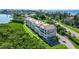 Aerial view of condo building showcasing waterfront location and lush landscaping at 4540 Gulf Of Mexico Dr # Ph1, Longboat Key, FL 34228