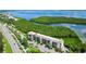 Aerial view of a condo building near the water with lush landscaping at 4540 Gulf Of Mexico Dr # Ph1, Longboat Key, FL 34228