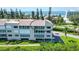 Condo building with ocean views and lush landscaping at 4540 Gulf Of Mexico Dr # Ph1, Longboat Key, FL 34228