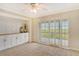 Bedroom with white built-ins and access to a screened balcony at 4540 Gulf Of Mexico Dr # Ph1, Longboat Key, FL 34228