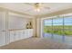 Bedroom with white built-ins and access to a screened balcony at 4540 Gulf Of Mexico Dr # Ph1, Longboat Key, FL 34228