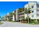 Condo building with palm trees and a parking area at 4540 Gulf Of Mexico Dr # Ph1, Longboat Key, FL 34228