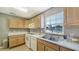 Simple kitchen with white appliances and wood cabinets at 4540 Gulf Of Mexico Dr # Ph1, Longboat Key, FL 34228