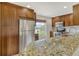 Kitchen with granite countertops, stainless steel appliances, and wood cabinets at 4540 Gulf Of Mexico Dr # Ph1, Longboat Key, FL 34228