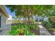 Relaxing landscaped grounds with a tree and a bench at 4540 Gulf Of Mexico Dr # Ph1, Longboat Key, FL 34228