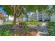 Landscaped grounds with a tree and a park bench at 4540 Gulf Of Mexico Dr # Ph1, Longboat Key, FL 34228