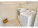 Laundry room with washer and dryer, shelving and tile floor at 4540 Gulf Of Mexico Dr # Ph1, Longboat Key, FL 34228