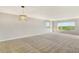 Bright living room with large windows and neutral colored carpet at 4540 Gulf Of Mexico Dr # Ph1, Longboat Key, FL 34228