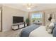 Main bedroom with access to lanai and TV at 4540 Gulf Of Mexico Dr # Ph1, Longboat Key, FL 34228