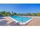 Community pool with surrounding patio furniture and tennis courts at 4540 Gulf Of Mexico Dr # Ph1, Longboat Key, FL 34228