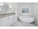 Elegant bathroom with freestanding tub, marble flooring, and vanity at 1400 Quail Dr, Sarasota, FL 34231