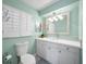 Charming bathroom with updated vanity, glass sink, and mint green walls at 1400 Quail Dr, Sarasota, FL 34231