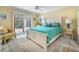 Bright bedroom with a queen-size bed and access to a private patio at 1400 Quail Dr, Sarasota, FL 34231