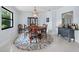 Elegant dining room features a round table and a unique rug at 1400 Quail Dr, Sarasota, FL 34231