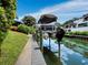 Private dock with a pontoon boat at 1400 Quail Dr, Sarasota, FL 34231