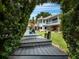 Steps leading down to a dock, with a view of the house beyond at 1400 Quail Dr, Sarasota, FL 34231