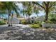 Gray house with palm trees, driveway, and landscaped yard at 1400 Quail Dr, Sarasota, FL 34231