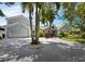 Two-story house with palm trees and a circular driveway at 1400 Quail Dr, Sarasota, FL 34231