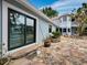 Home exterior showcasing a stone patio and access to the backyard at 1400 Quail Dr, Sarasota, FL 34231