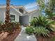 Front entrance with walkway, landscaping, and mature plants at 1400 Quail Dr, Sarasota, FL 34231