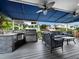 Outdoor kitchen with grill and seating area at 1400 Quail Dr, Sarasota, FL 34231