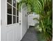 Private outdoor shower with white louvered doors and a wooden walkway at 1400 Quail Dr, Sarasota, FL 34231