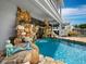 Relaxing pool with a mermaid statue and stone waterfall feature at 1400 Quail Dr, Sarasota, FL 34231