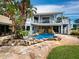 Inviting pool area with a waterfall feature and stone patio at 1400 Quail Dr, Sarasota, FL 34231