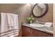 Elegant powder room with granite vanity and decorative wallpaper at 445 N Orange Ave # 309, Sarasota, FL 34236