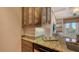 Modern kitchen with glass-front cabinets and granite countertops at 445 N Orange Ave # 309, Sarasota, FL 34236