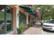 Retail space with green awning and sidewalk seating at 445 N Orange Ave # 309, Sarasota, FL 34236