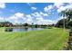 Serene backyard with lake view and lush grass at 10622 Cheval Pl, Lakewood Ranch, FL 34202