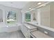 Elegant bathroom featuring a soaking tub, double vanity and large mirror at 10622 Cheval Pl, Lakewood Ranch, FL 34202